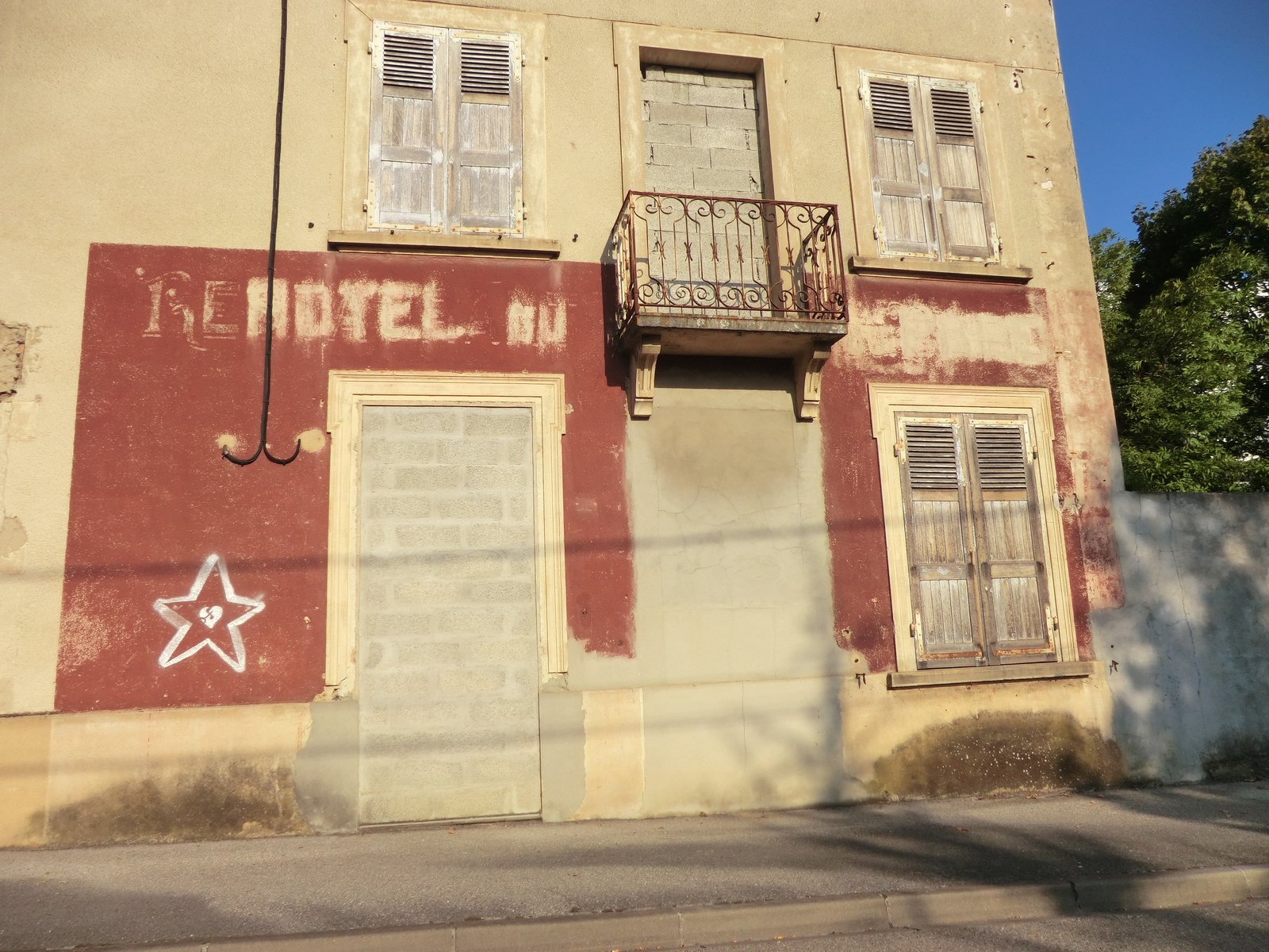 Faded painted Hotel du Parc and Restaurant du Parc ghost signs on a rendered wall at Saint-Maurice-de-Beynost, France